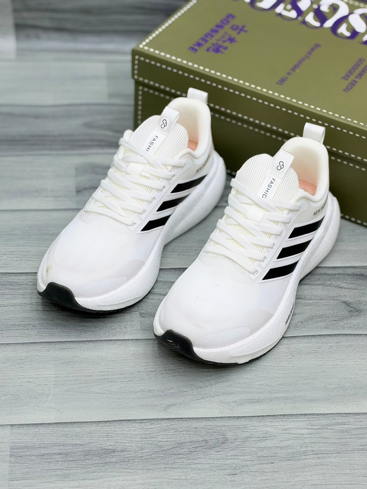 White Gossgeke chunky sneakers with black stripes and cushioned sole, front view