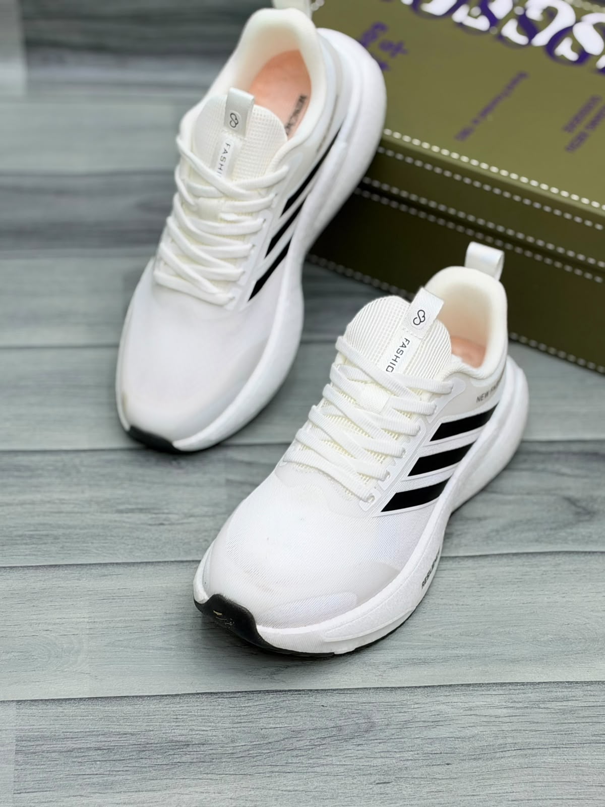 White Gossgeke chunky sneakers with black stripes and cushioned sole, front view