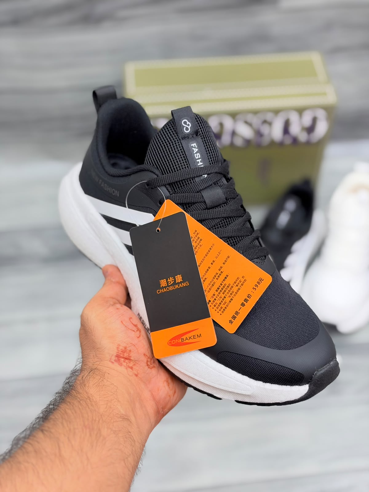 Black Gossgeke chunky sneakers with white three-stripe design and thick white sole, top-angle view